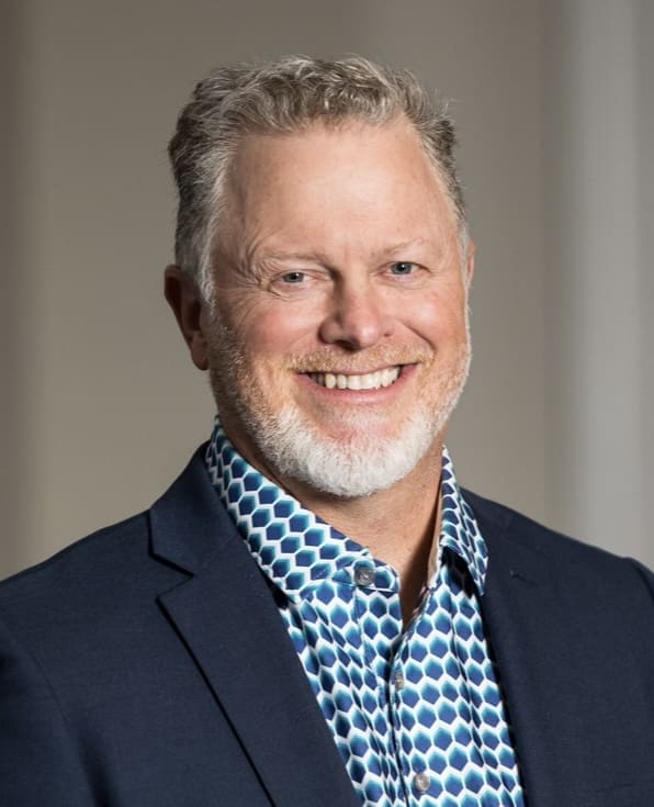 Smiling man in patterned shirt and jacket. Smiling man in patterned shirt and jacket.
